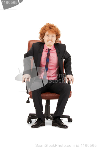 Image of young businessman sitting in chair