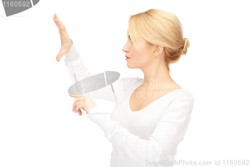 Image of businesswoman working with something imaginary