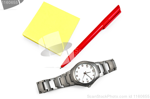 Image of Yellow paper with a red pen, wristwatch