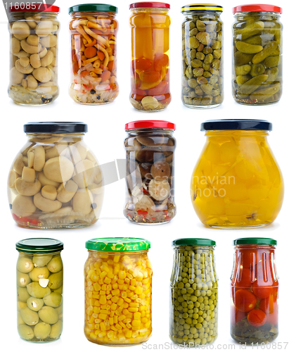 Image of Set of different berries, mushrooms and vegetables conserved in glass jars