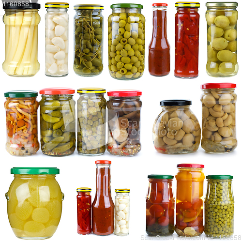 Image of Set of different berries, mushrooms and vegetables conserved in glass jars