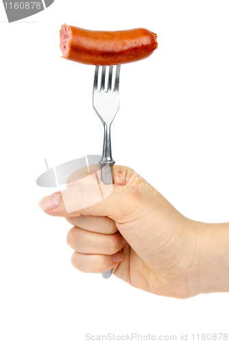 Image of Hand holding half eaten sausage on fork.