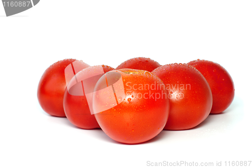 Image of Six juicy tomatoes with drops of water