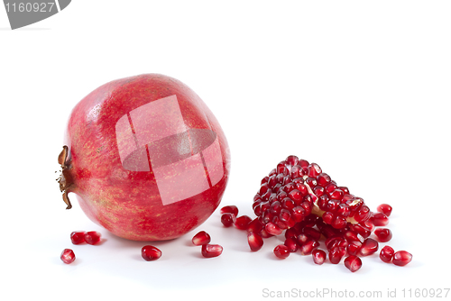 Image of Whole pomegranate\ piece and some beries