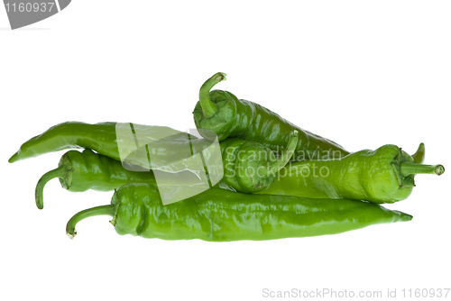 Image of Four green chili peppers