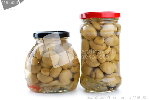 Image of Two glass jars with marinated champignons