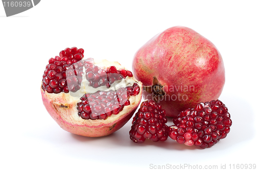 Image of Whole pomegranate, half and pieces