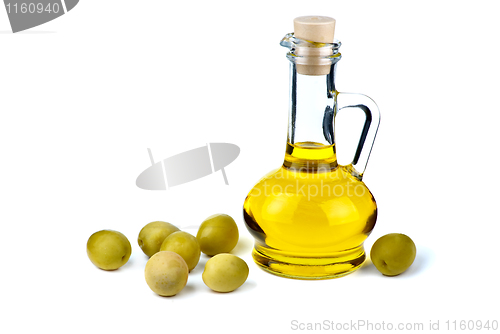 Image of Small decanter with olive oil and some olives near