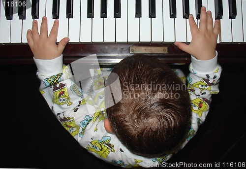 Image of Infant playing the piano