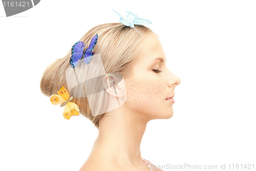 Image of beautiful woman with butterfly in hair