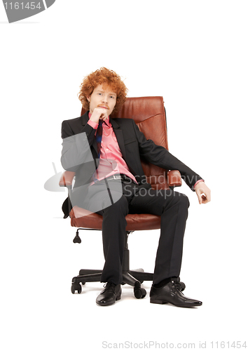 Image of young businessman sitting in chair