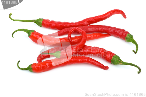 Image of Some long curved red chili peppers