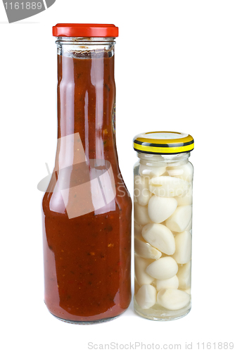 Image of Bottles with tomato ketchup and marinated garlic