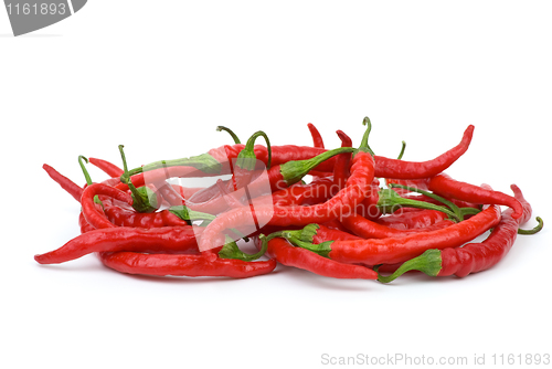 Image of Pile of long curved red hot chili peppers