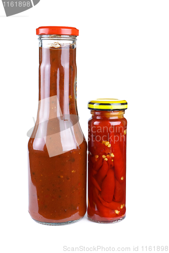 Image of Bottles with tomato ketchup and marinated red hot chili peppers