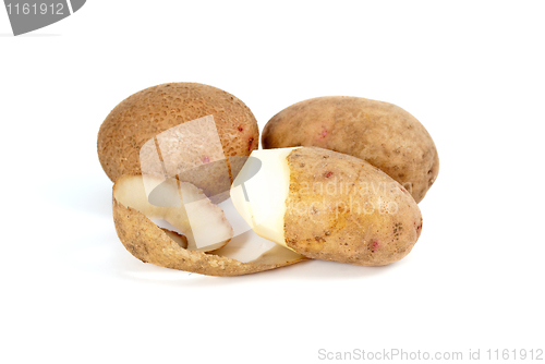 Image of Potatoes. Whole and half-peeled