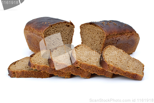Image of Two chunks of rye bread with anise and some slices