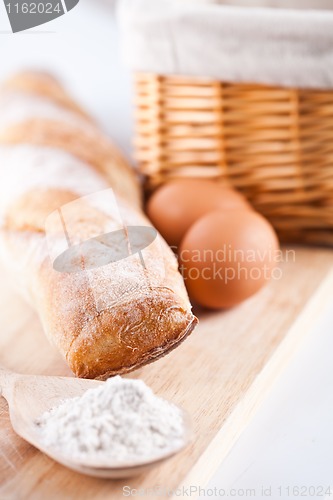 Image of bread, flour, eggs and kitchen utensil