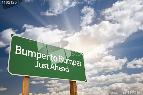 Image of Bumper to Bumper Green Road Sign and Clouds