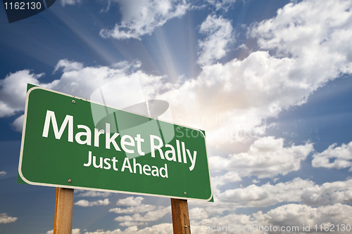 Image of Market Rally Green Road Sign and Clouds