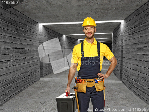 Image of manual worker in concrete tunnel background