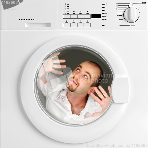 Image of funny portrait of man inside washing machine