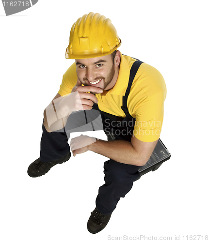 Image of smiling manual worker rest on toolbox