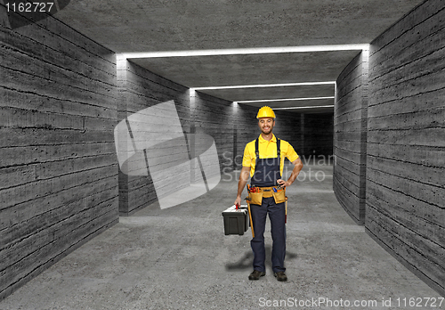 Image of construction worker in concrete tunnel background