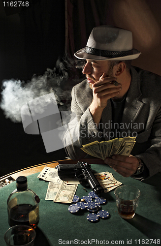 Image of gangster smoking and play poker