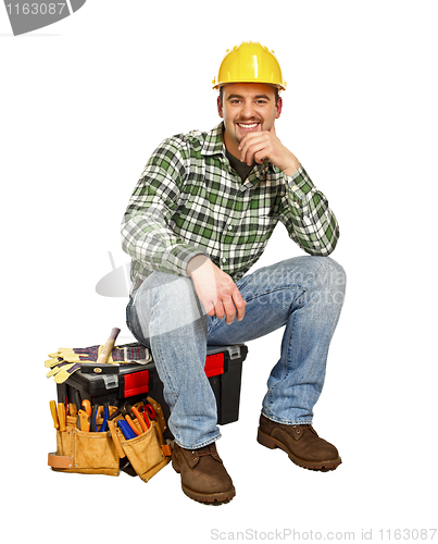 Image of young handyman sit on toolbox