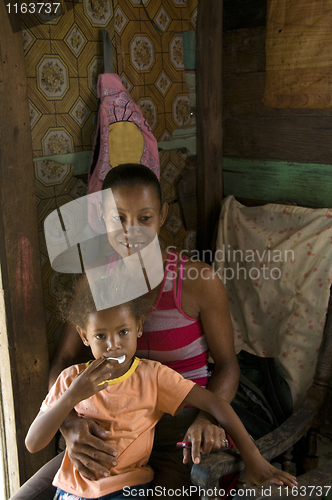 Image of Nicaragua mother child daughter interior clapboard house Corn Is