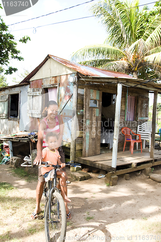 Image of Nicaragua mother daughter bicycle poverty house Corn Island