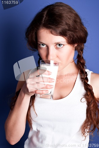 Image of young woman drinking a milk 