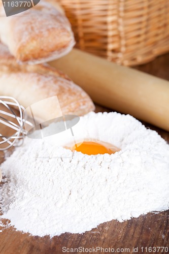 Image of bread, flour, eggs and kitchen utensil 