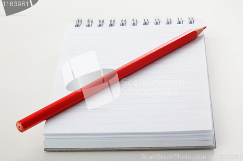 Image of The notepad and red pencil