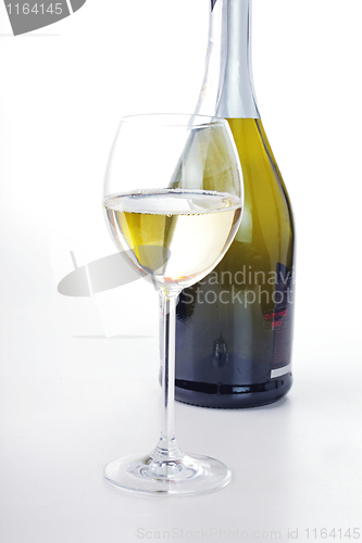 Image of The glass of wine and a bottle