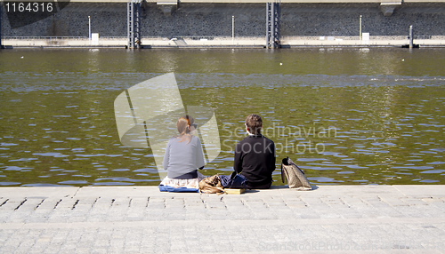 Image of people sitting on the creek. rest.