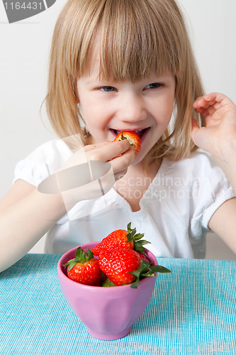 Image of LIttle girl eating strawberries