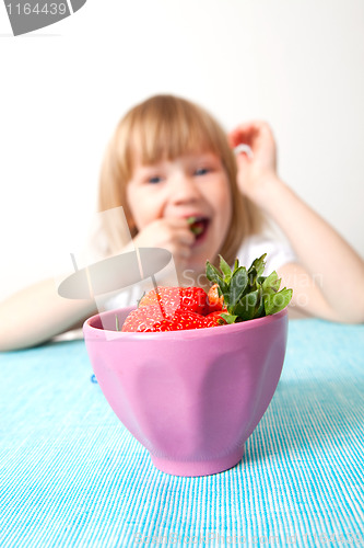 Image of LIttle girl eating strawberries