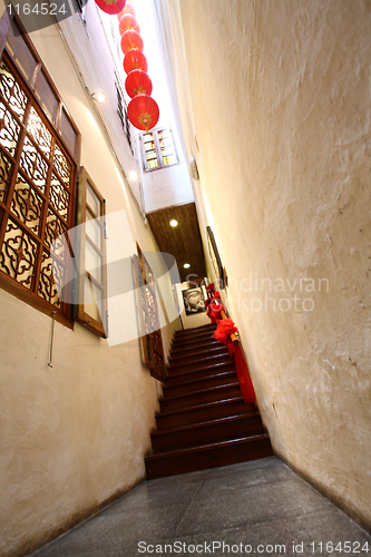 Image of Chinese traditional corridor in wooden with red lantern.