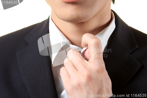 Image of picture of a business man adjusting his suit