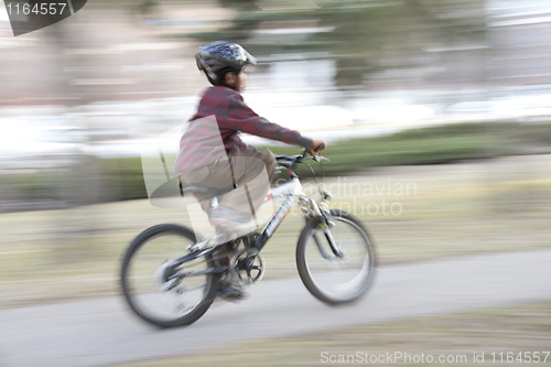 Image of Young boy riding a bike