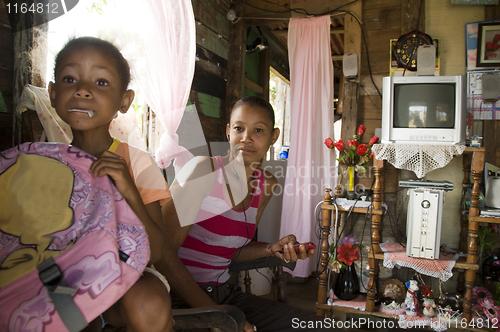 Image of Nicaragua mother child daughter interior clapboard house Corn Is