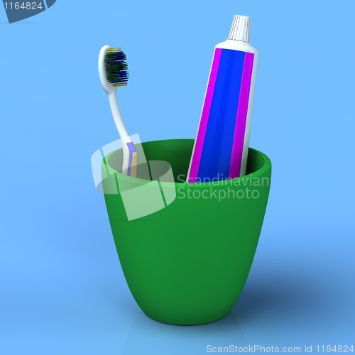Image of Toothbrush and gel toothpaste in  green cup