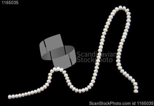 Image of White pearls on the black silk 