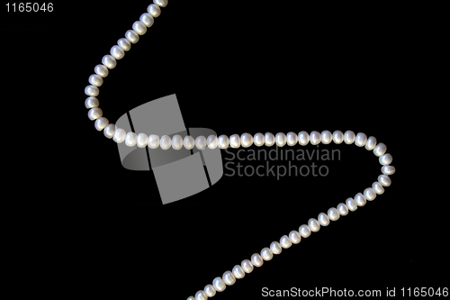 Image of White pearls on the black silk