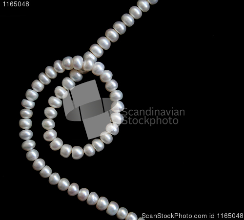 Image of White pearls on the black silk 