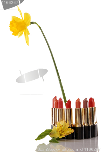 Image of glamor red shiny lipstick and yellow flower