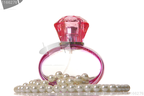 Image of Perfume in a glass bottle and pearl beeds