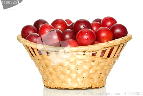 Image of Wicker basket with cherry plums